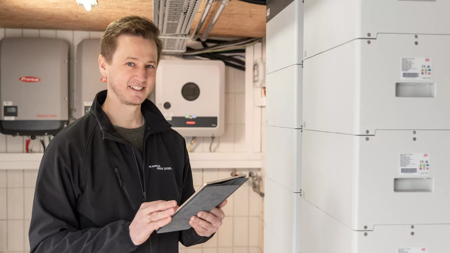 Customer in front of inverter monitoring with tablet