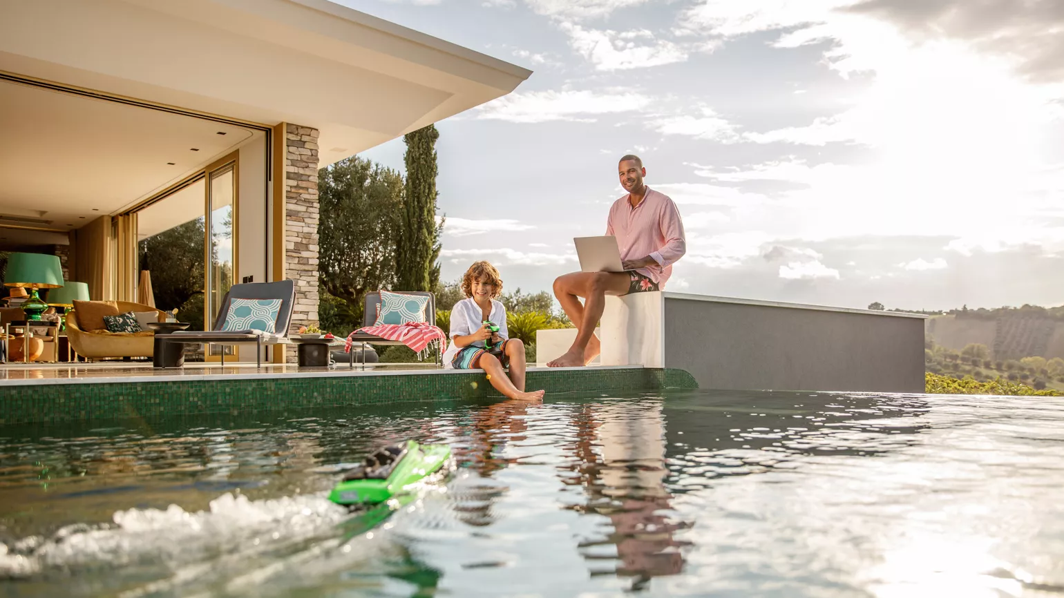 Father and son in front of pool