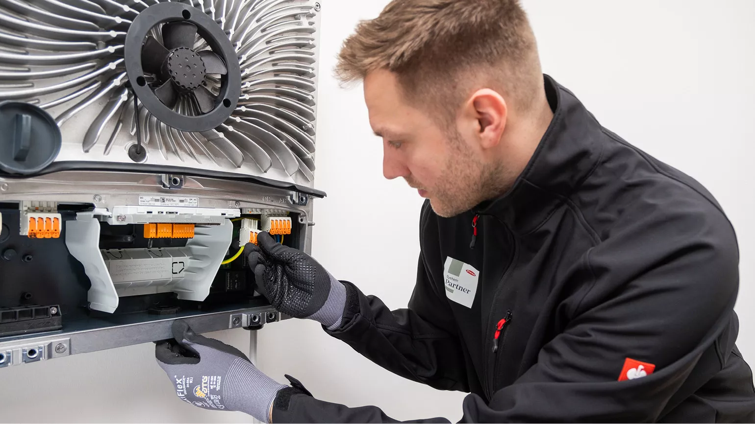 PV installer installing the PV Point Comfort board into a GEN24 inverter